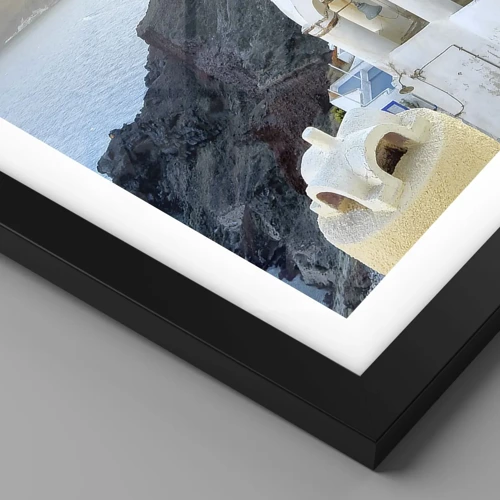 Affiche dans un cadre noir - Poster - Santorin - blotti contre les rochers - 50x50 cm