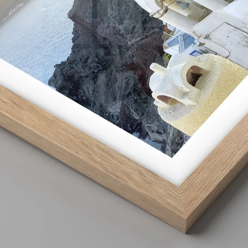 Affiche dans un chêne clair - Poster - Santorin - blotti contre les rochers - 50x50 cm
