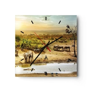 Horloge murale - Pendule murale - Éléphants et animaux sauvages à un point d'eau au coucher du soleil - 30x30cm - "Et d'Eden coulait une rivière..." - Décoration murale moderne pour le salon et la chambre ARTTOR
