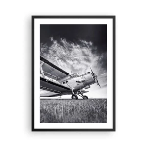 Affiche dans un cadre noir - Poster - Une image en noir et blanc d'un avion contre un ciel dynamique. - 50x70cm - Le pèlerin ailé - Décoration murale moderne pour le salon et la chambre ARTTOR