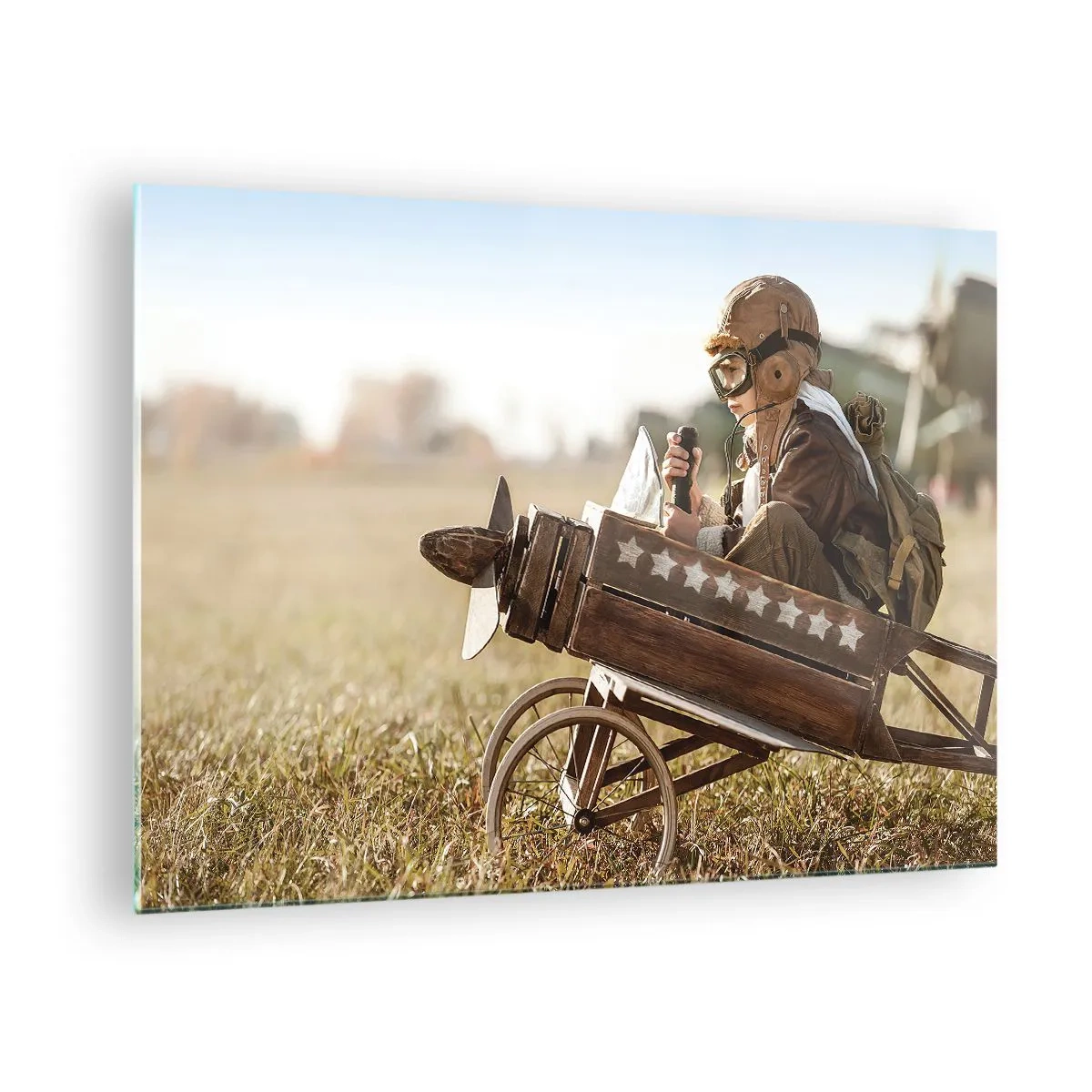 Impression sur verre - Image sur verre - Un enfant dans un avion en bois, faisant semblant d'être un pilote, portant des vêtements d'aviateur. - 70x50cm - Départ vers un rêve - Décoration murale moderne pour le salon et la chambre ARTTOR
