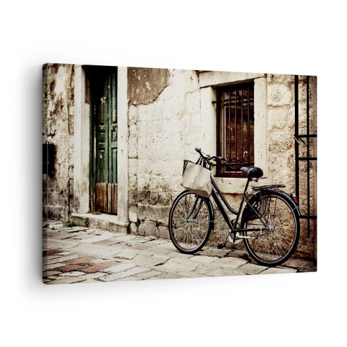Impression sur toile - Image sur toile - Un vélo contre un mur de pierre avec une fenêtre et une porte de style rétro - 70x50cm - Retour au passé - Décoration murale moderne pour le salon et la chambre ARTTOR