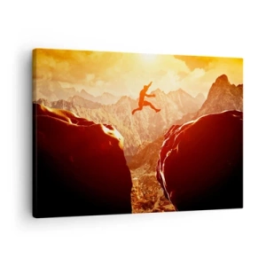 Impression sur toile - Image sur toile - Une silhouette sautant entre des rochers avec des montagnes en arrière-plan - 70x50cm - Dépassement des limites - Décoration murale moderne pour le salon et la chambre ARTTOR