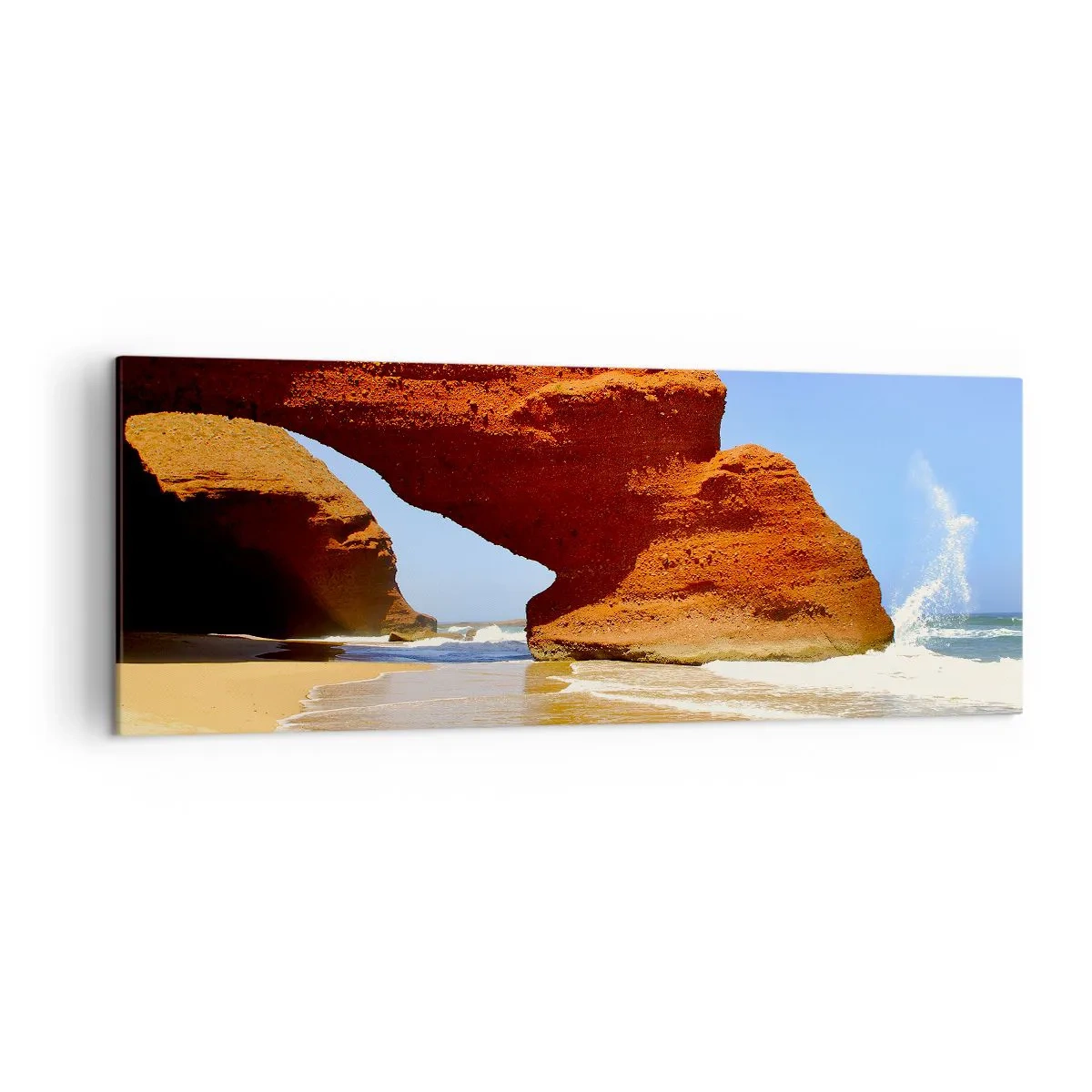 Impression sur toile - Image sur toile - Une arche rocheuse naturelle sur une plage avec un ciel bleu et des vagues - 140x50cm - L'eau et le vent depuis des milliers d'années - Décoration murale moderne pour le salon et la chambre ARTTOR