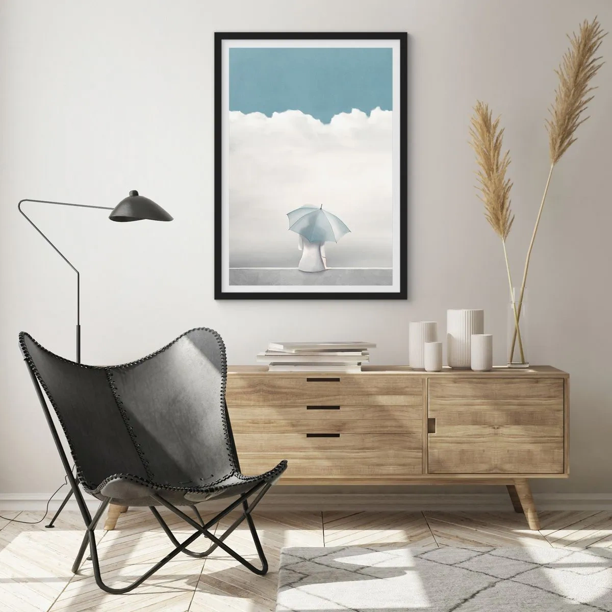 Affiche dans un cadre noir - Poster - Une silhouette avec un parapluie assise sur un rebord parmi les nuages - 50x70cm - Aux confins de la réalité et des rêves - Décoration murale moderne pour le salon et la chambre ARTTOR
