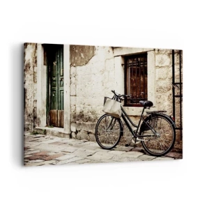 Impression sur toile - Image sur toile - Un vélo contre un mur de pierre avec une fenêtre et une porte de style rétro - 100x70cm - Retour au passé - Décoration murale moderne pour le salon et la chambre ARTTOR