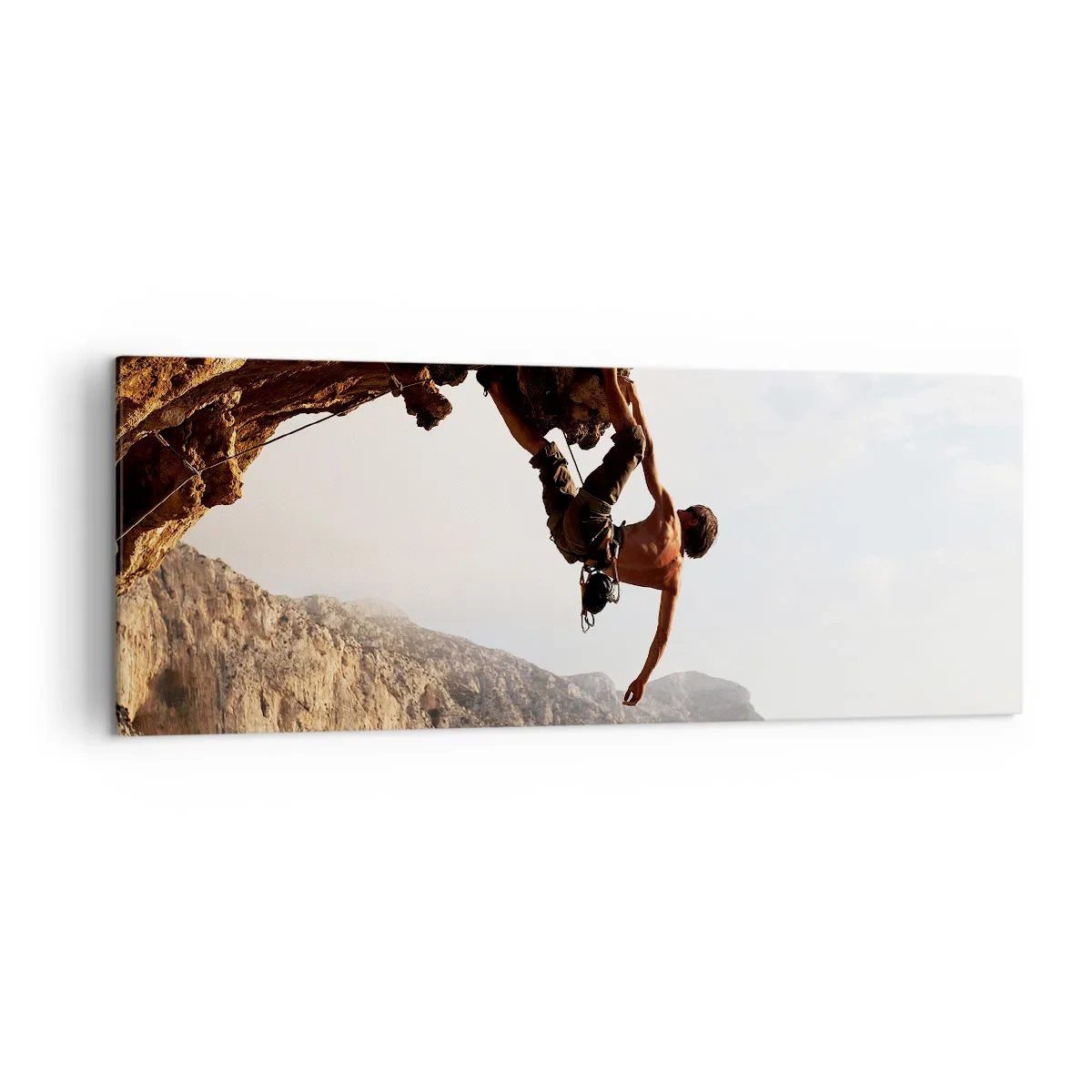 Impression sur toile - Image sur toile - Un grimpeur sur une falaise abrupte dans les montagnes au soleil - 140x50cm - Le monde rétréci dans une main sur une coupe de rocher - Décoration murale moderne pour le salon et la chambre ARTTOR