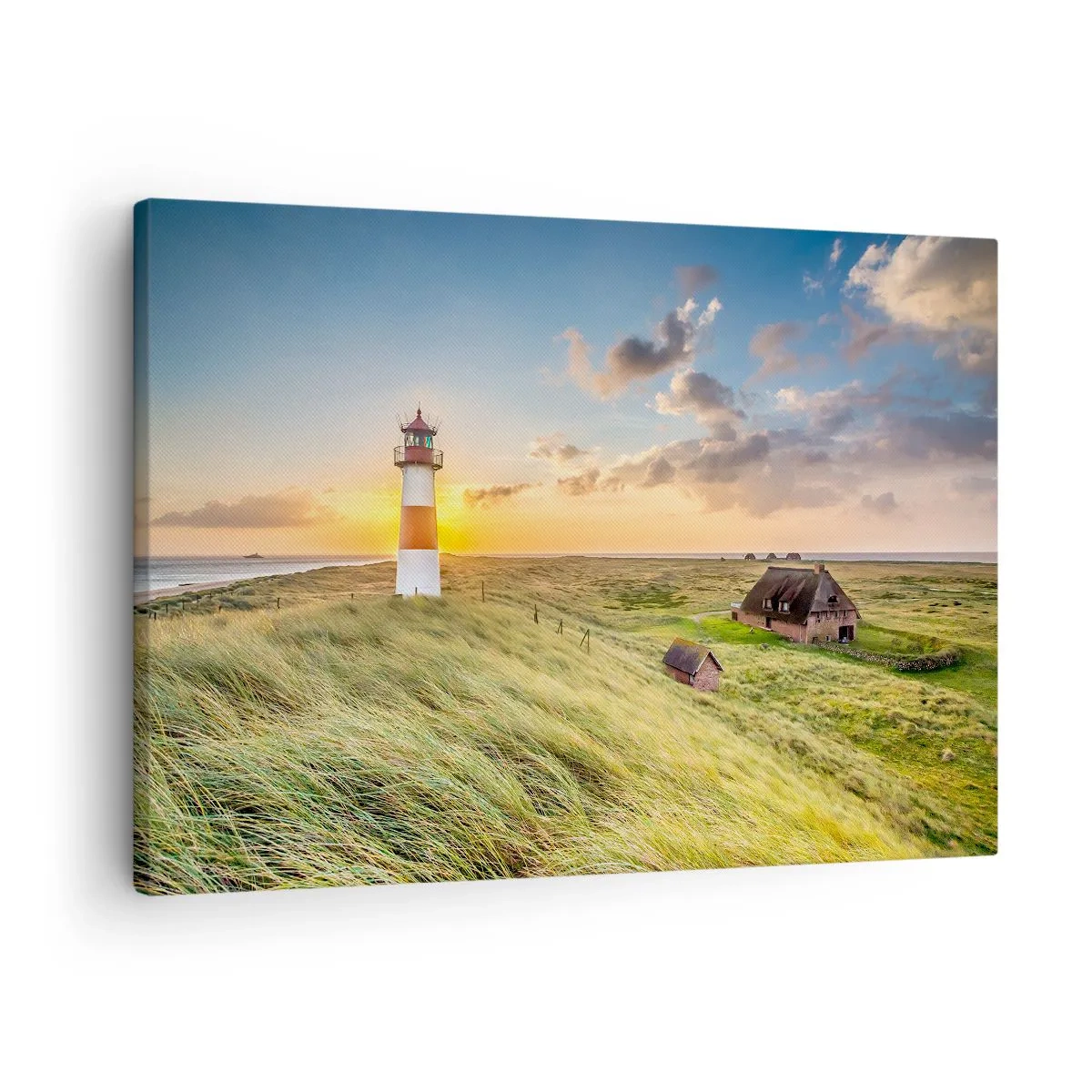 Impression sur toile - Image sur toile - Un phare avec des prairies et des maisons au soleil en arrière-plan - 70x50cm - Entre les vagues - Décoration murale moderne pour le salon et la chambre ARTTOR