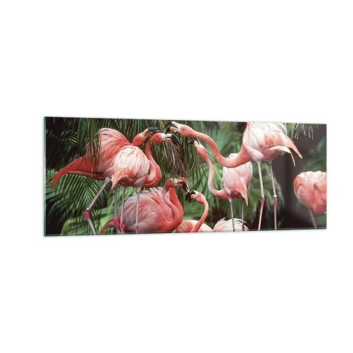 Impression sur verre - Image sur verre - Un groupe de flamants roses dans un cadre tropical entouré de palmiers - 140x50cm - Potins d'après-midi - Décoration murale moderne pour le salon et la chambre ARTTOR