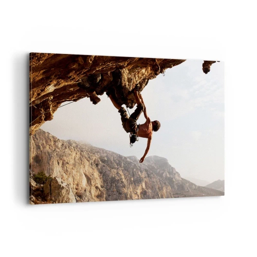 Impression sur toile - Image sur toile - Un grimpeur sur une falaise abrupte dans les montagnes au soleil - 100x70cm - Le monde rétréci dans une main sur une coupe de rocher - Décoration murale moderne pour le salon et la chambre ARTTOR